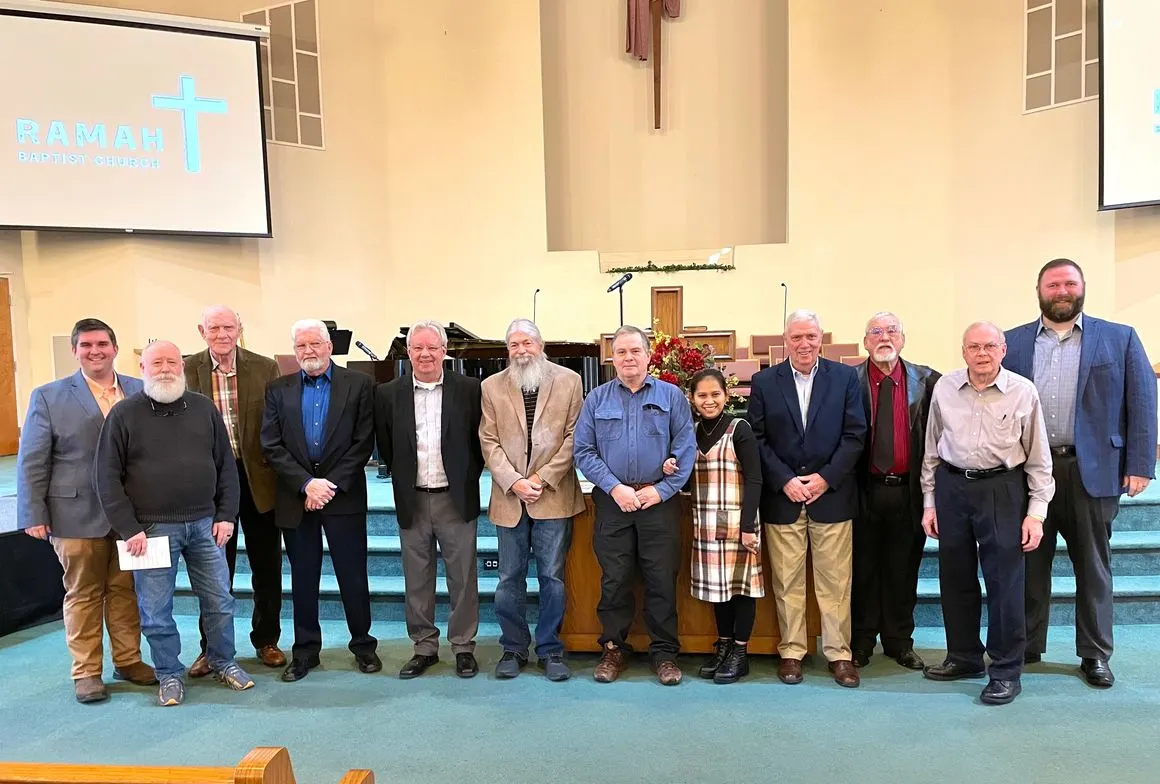 Men of the church standing together at the front of the sanctuary
